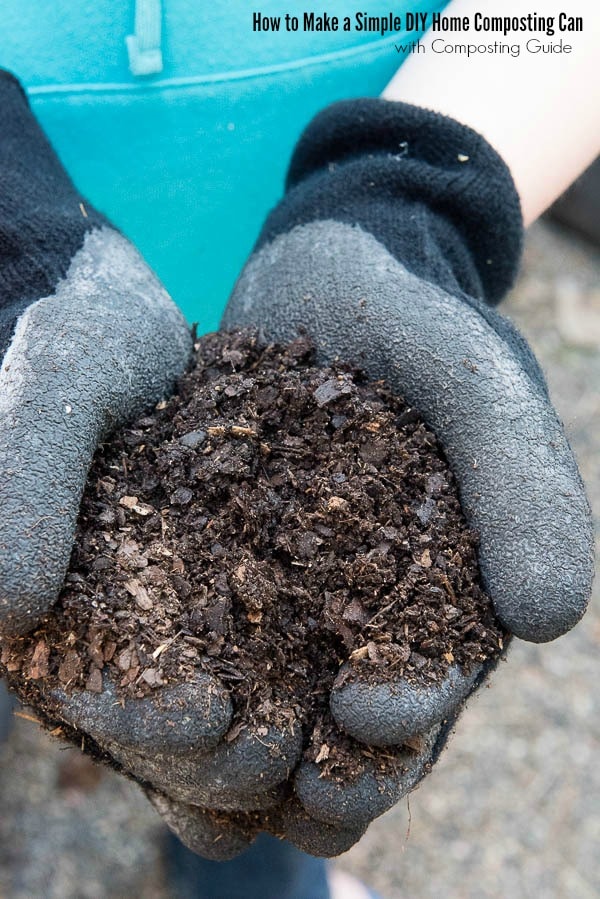 gloved hands holding compost from a home composting can