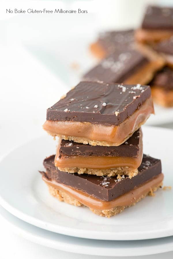 stack of three gluten-free millionaire bars on a white dessert plate