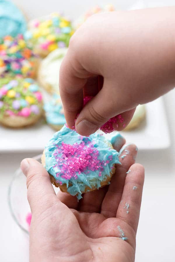 Springtime Gluten-Free Frosted Sugar Cookies - Adding sprinkles