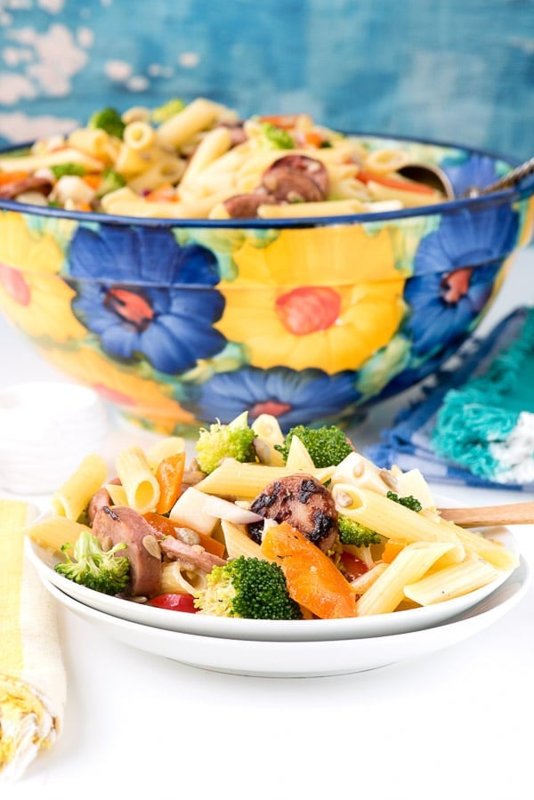 a small round plate with a serving of Broccoli Sausage Pasta Salad
