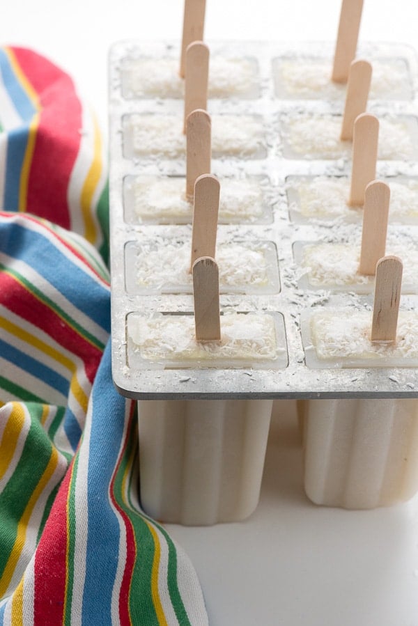 homemade popsicle mold filled with coconut banana popsicles