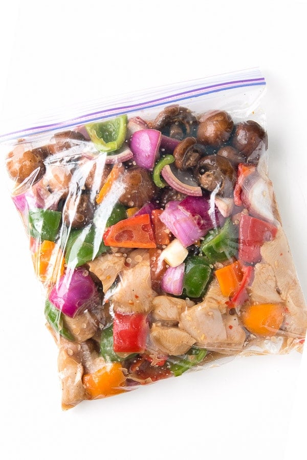  Colorful ingredients for Easy Grilled Chicken Shish Kabobs marinating in plastic zipper bag