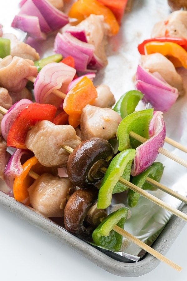  Close-up of colorful Easy Grilled Chicken Shish Kabobs with red onion, green pepper on skewers