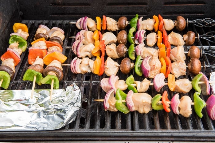 10-minute Easy Grilled Chicken Shish Kabobs on grill with foil skewer guard