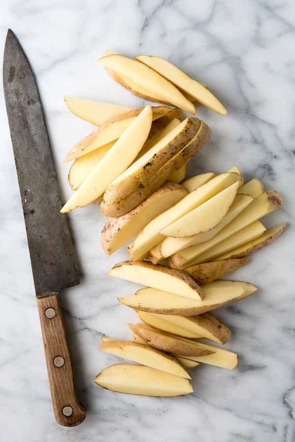 sliced potato wedges and a sharp chef\'s knife