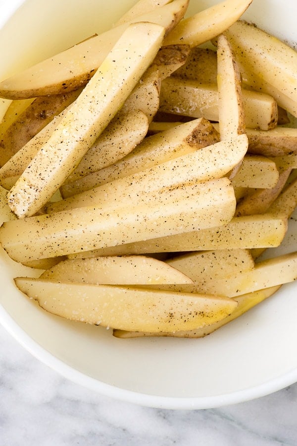 a bowl of Homemade Oven Fries seasoned with salt and black pepper