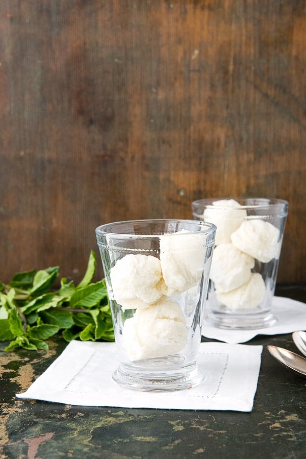 2 clear glasses filled with scoops of homemade mint ice cream to make ice cream floats