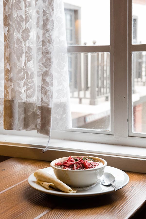 bowl of Red Posole Soup sits on a window-side table at the Inn of the Governors, Santa Fe, New Mexico.