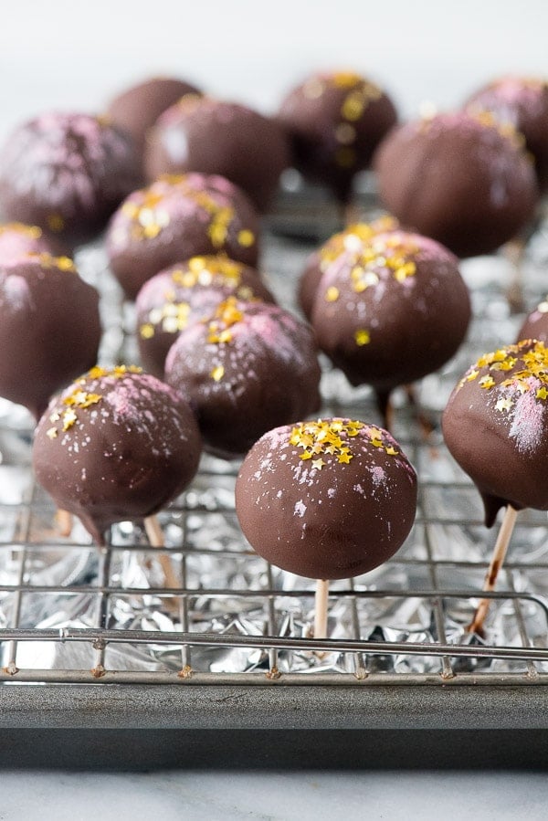 homemade chocolate truffles on toothpicks to allow the excess chocolate to drip off