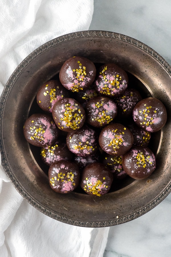 Rose-flavored Dark Chocolate Truffles sitting in an antique silver serving bowl