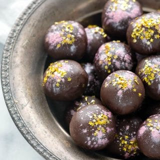 a silver bowl full of rose-flavored dark chocolate truffles