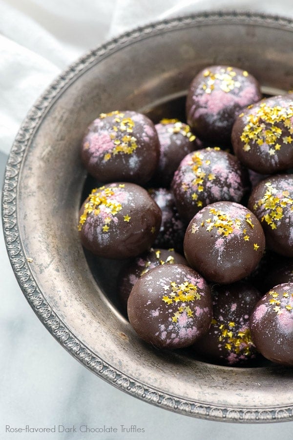 a silver bowl full of rose-flavored dark chocolate truffles