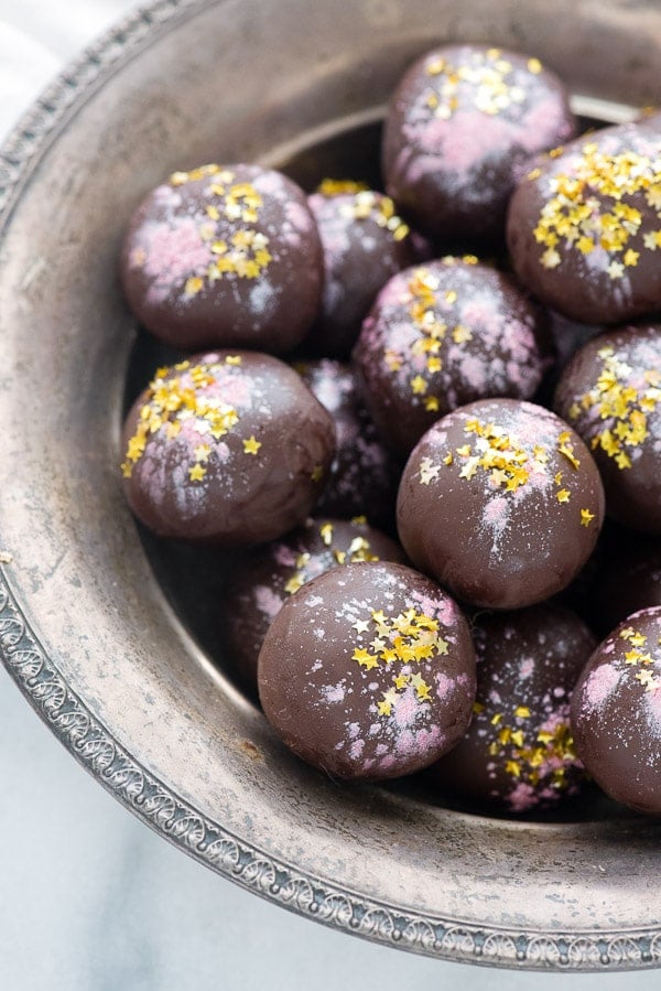 dark chocolate truffles infused with rose flavoring are rolled in edible gold glitter stars