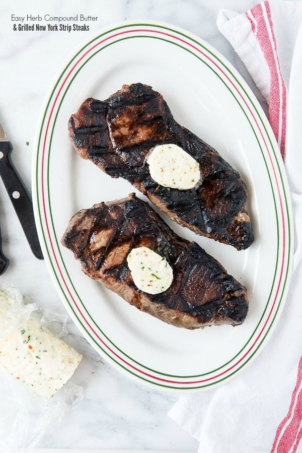 herb compound butter on grilled NY strip steaks