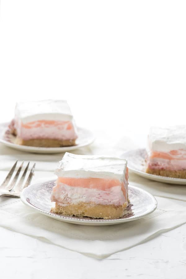 layered strawberry cheesecake dessert on a plate