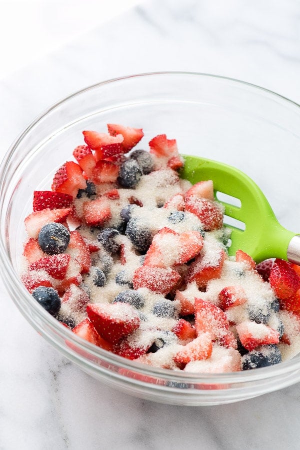 berries with sugar in a glass bowl