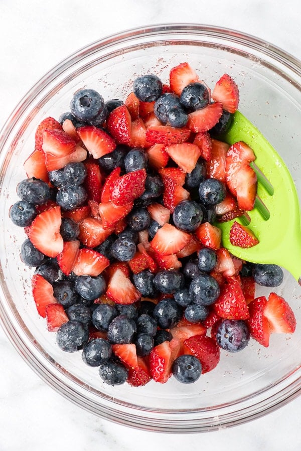 blueberries and strawberries in a glass a bowl