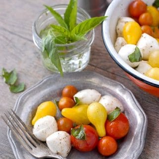 Bite-size Insalata Caprese on pewter plates