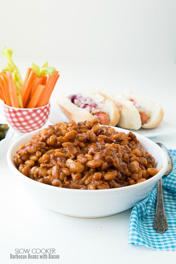Slow Cooker Barbecue Beans with Bacon with hot dogs in background