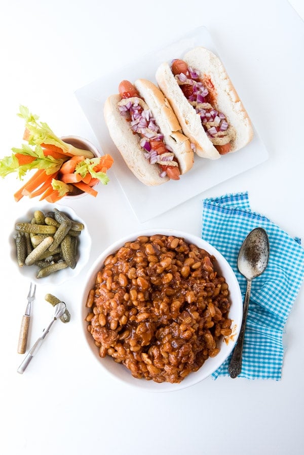 Slow Cooker Barbecue Beans with Bacon with hot dogs, sliced vegetables