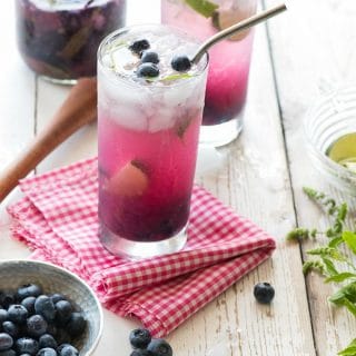 Blueberry Mojitos with metal straw on checked cloth