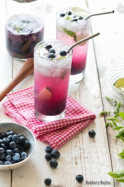 Blueberry Mojitos with metal straw on checked cloth
