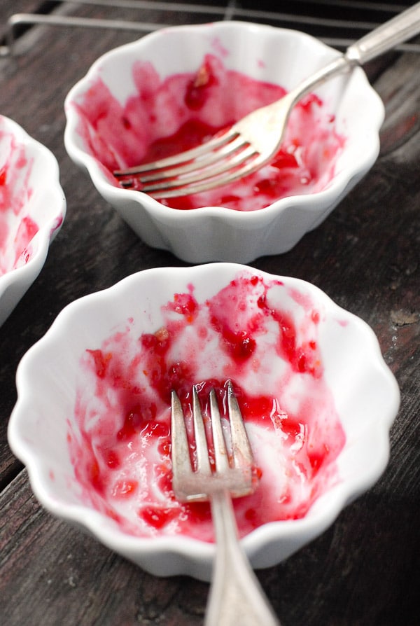 empty white bowls that had plum slump dessert in them