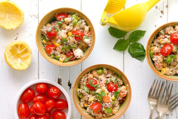 overhead view of bowls of Rainbow Quinoa Summer Salad with cherry tomatoes