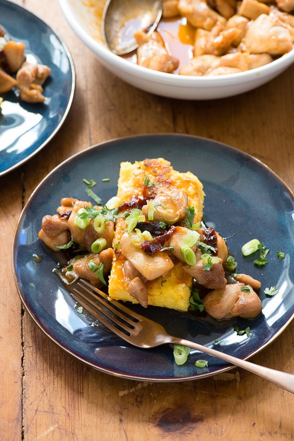 Sweet Chipotle Chicken Bites with Pan Fried Polenta on a blue plate