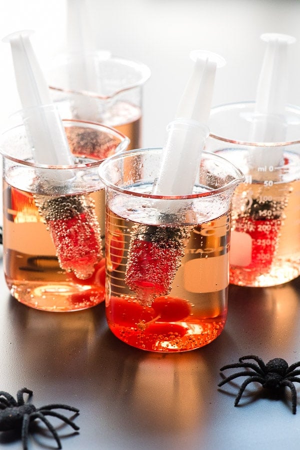 Creepy Shirley Temples. There's nothing like a few fun props to turn this simple mocktail into a Halloween horror! Shirley Temples served in glass beakers with blood-red grenadine in a liqueur shot syringe for fun! BoulderLocavore.com