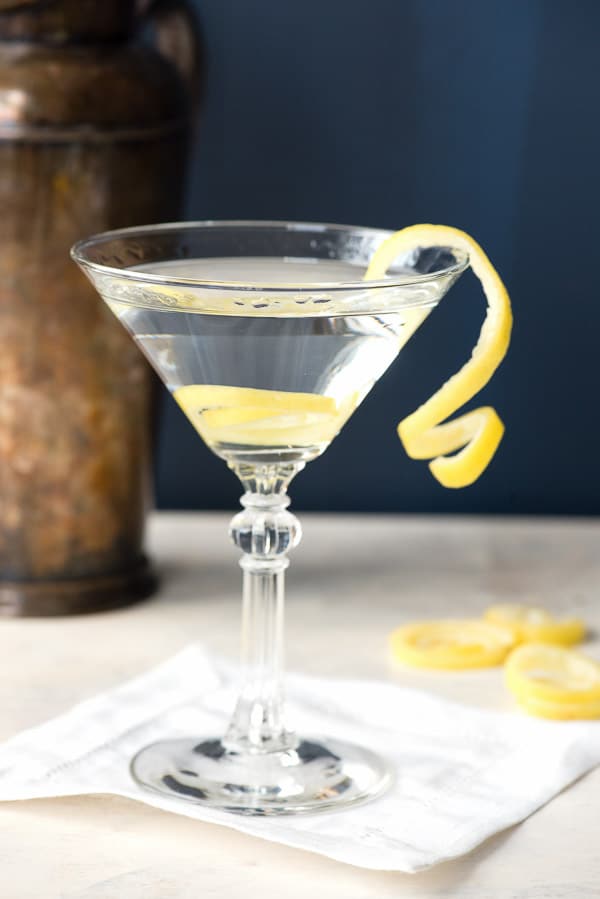 side view of cocktail glass with lemon spirals garnish