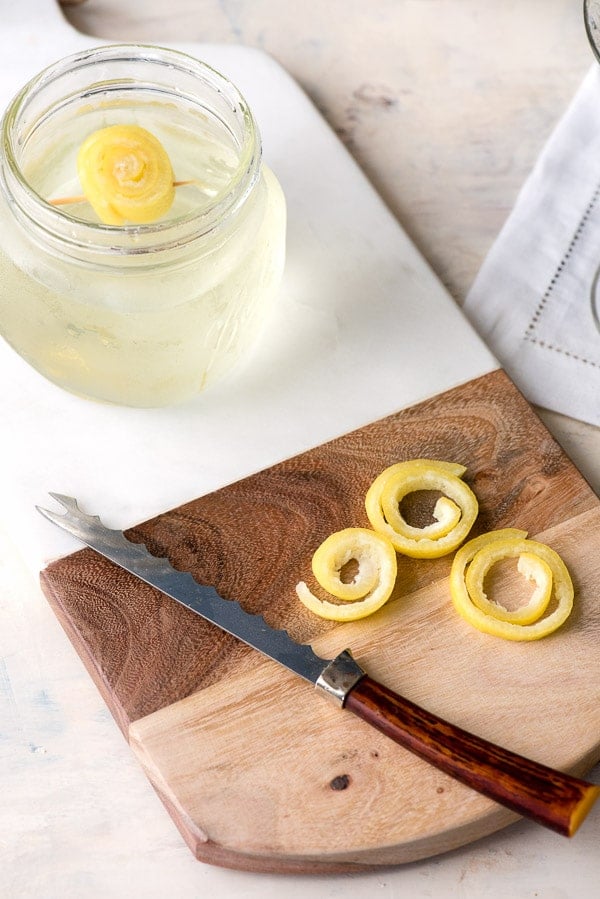 process of making lemon spirals with lemon peel soaking in water