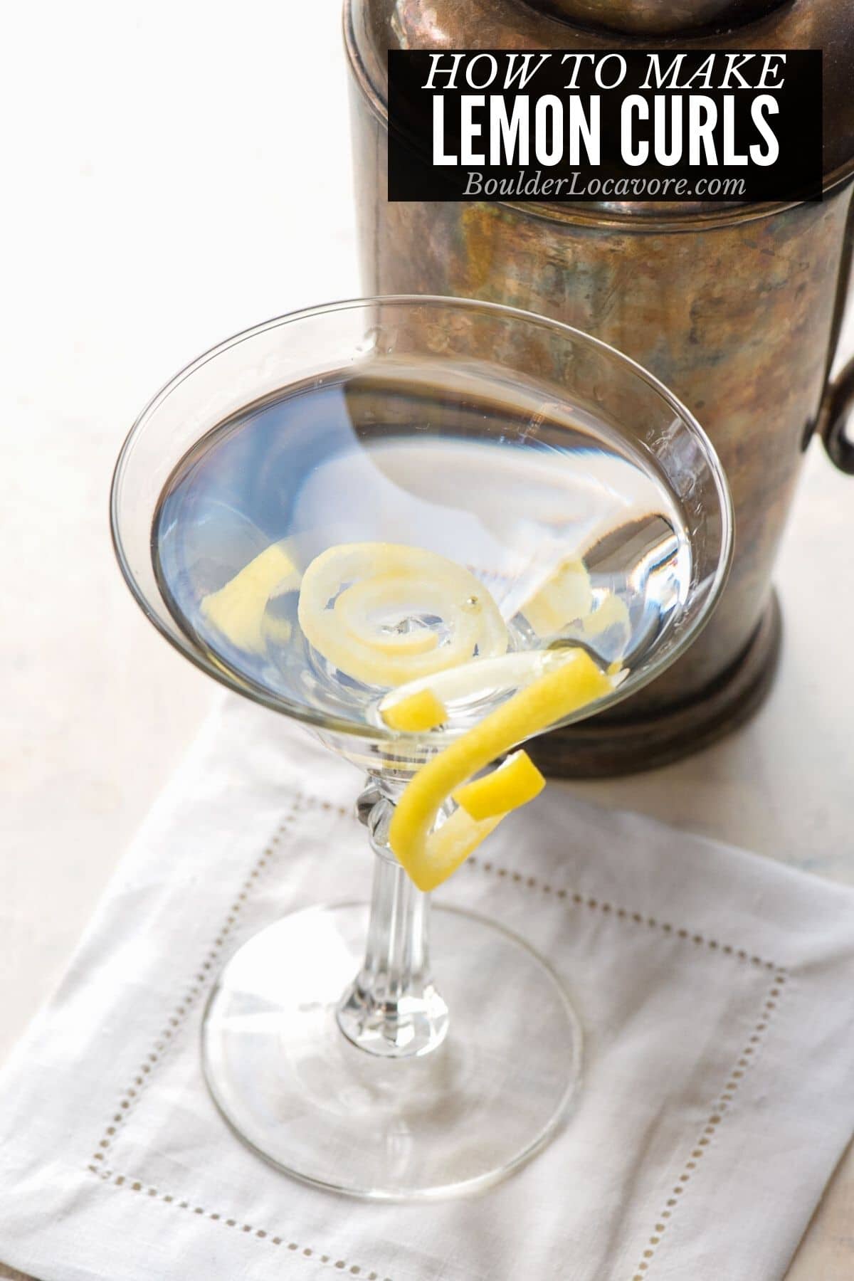 lemon curls on cocktail glass - titled image