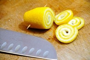 cutting rolled lemon peel into lemon curls