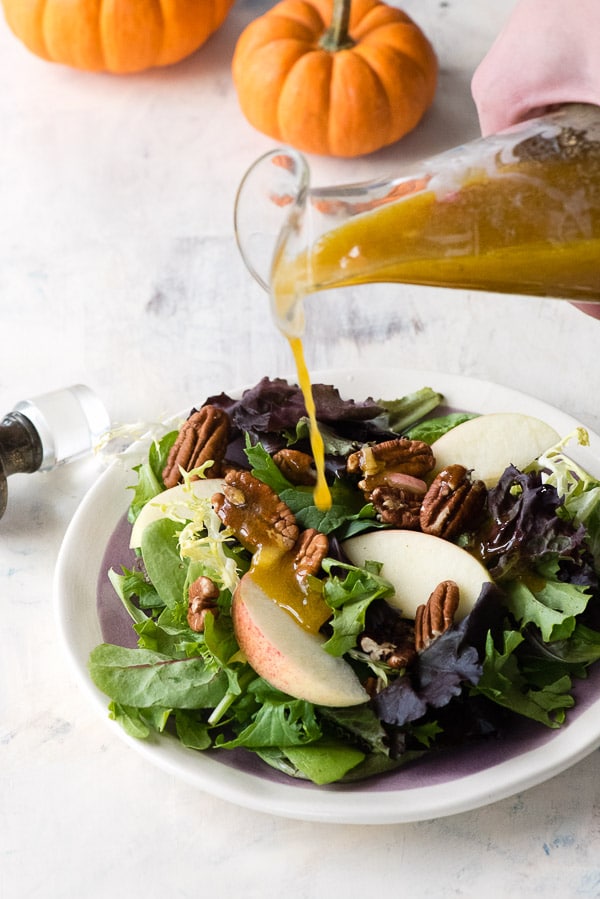 Maple Pumpkin Butter Vinaigrette pouring on salad