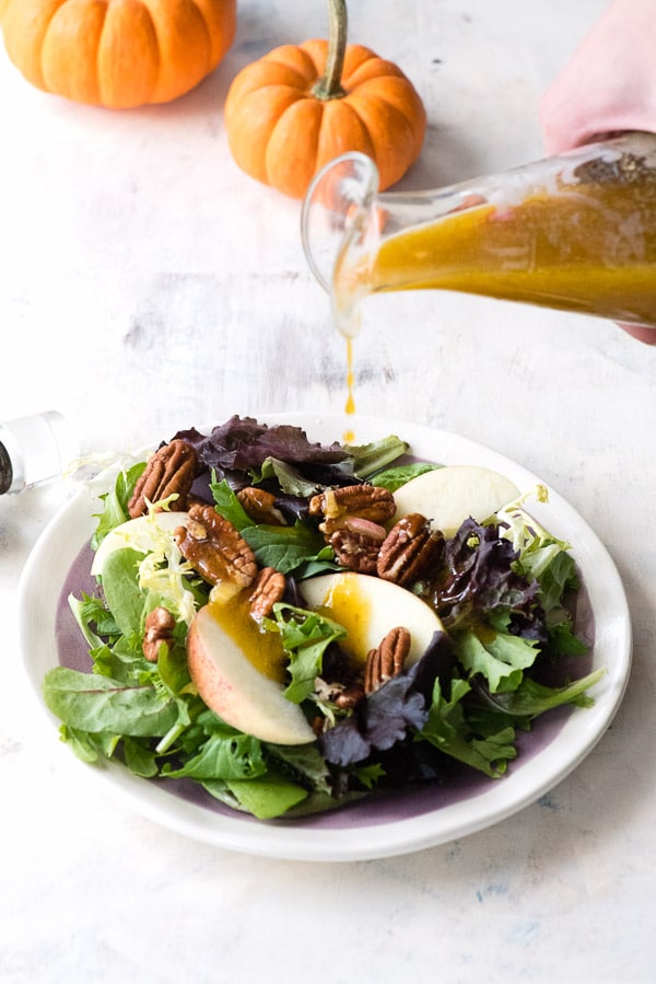 Maple Pumpkin Butter Vinaigrette poured on salad greens