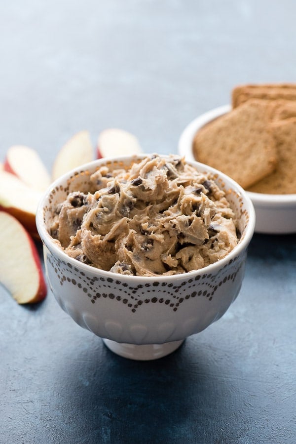 Pumpkin Spice Cookie Dough Dip in a decorative bowl with cookies and apple slices