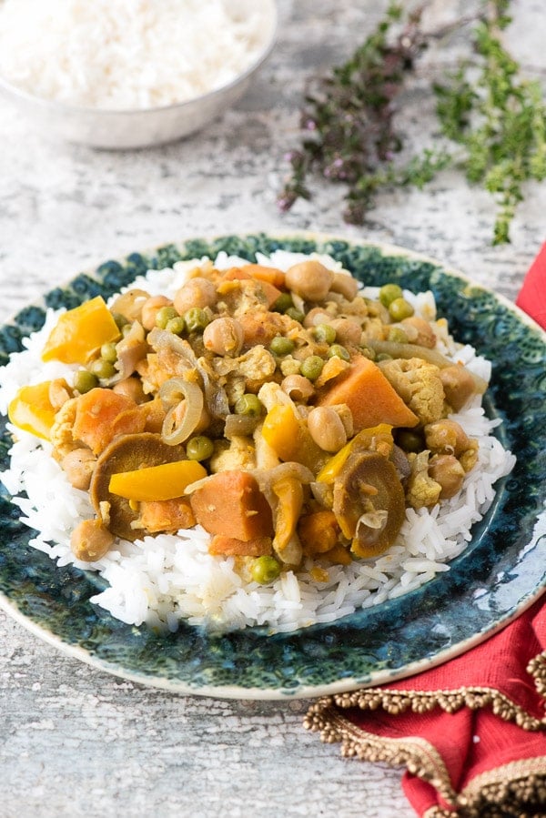 Slow Cooker Spicy Madras Vegetable Curry on rice and green plate