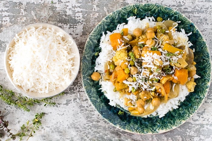 vegan Slow Cooker Spicy Madras Vegetable Curry from overhead on bed of rice