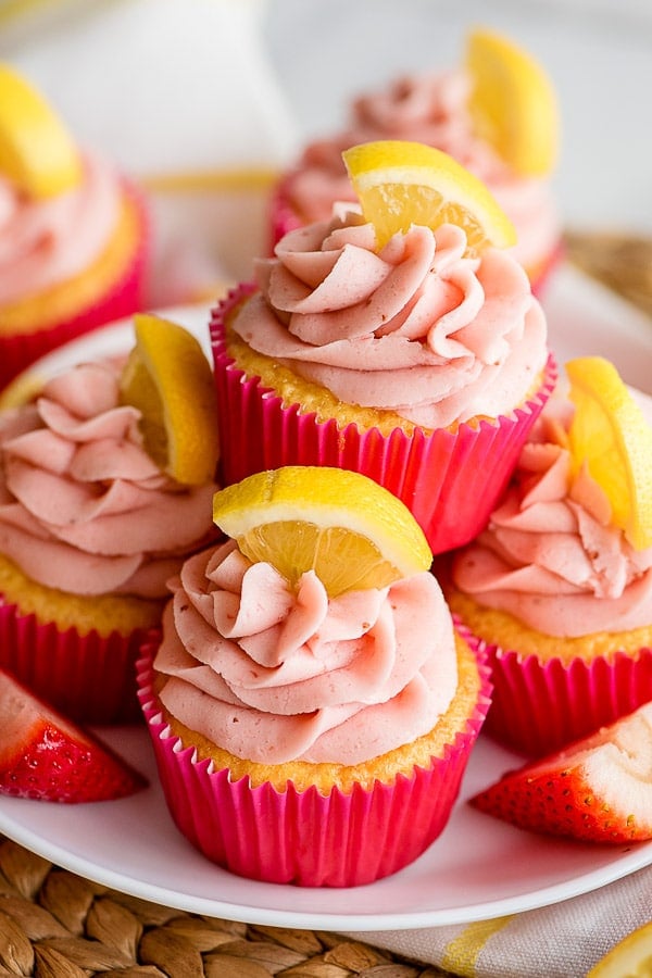 stack of lemon cupcakes with pink wrappers