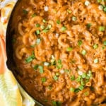 Cheesy Homemade Hamburger Helper pasta dish in large skillet with green onions