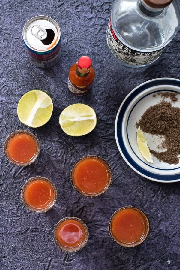 overhead of bloody maria shots with lime and smoked salt