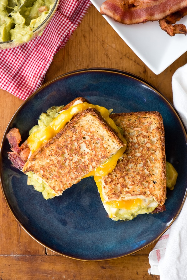 grilled cheese and bacon sandwich on blue plate