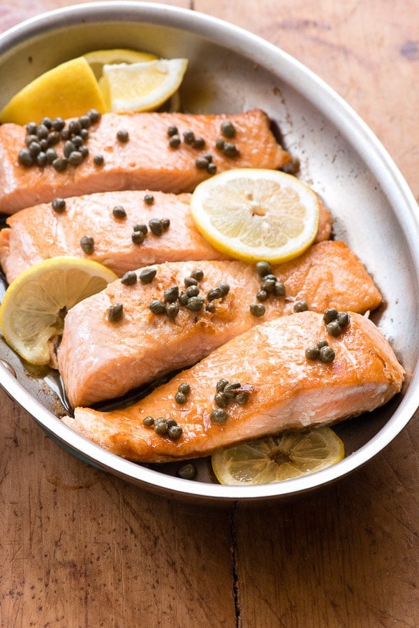 Pan Seared Salmon with capers and lemon in skillet