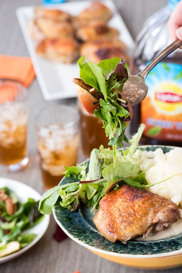 Roasted Sweet Tea Chicken Thighs with salad and glasses of iced tea in background