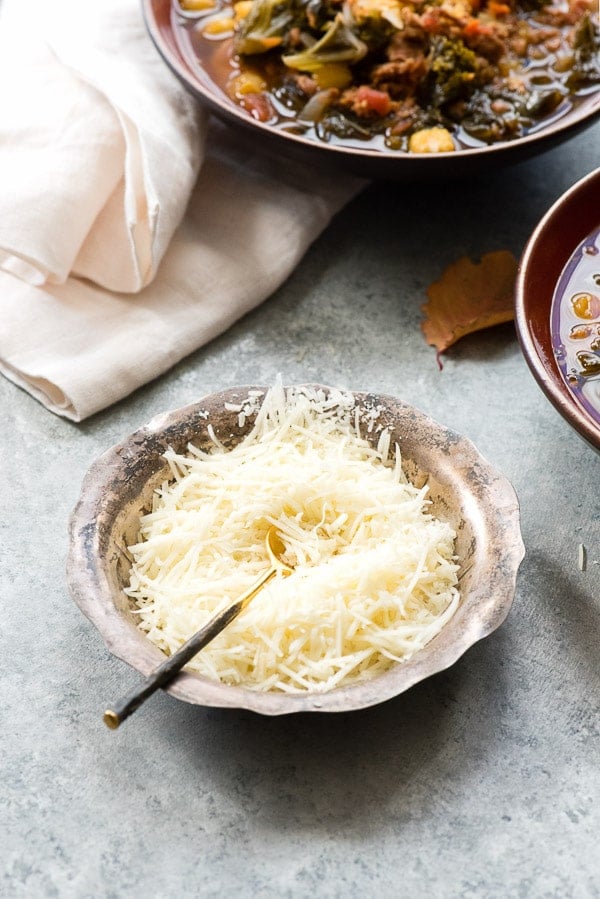 grated cheese in bowl with spoon