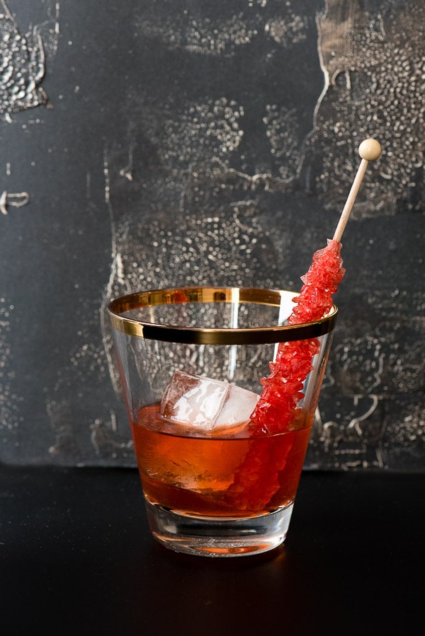 A glass cup on a table, with Old fashioned and Rye whiskey