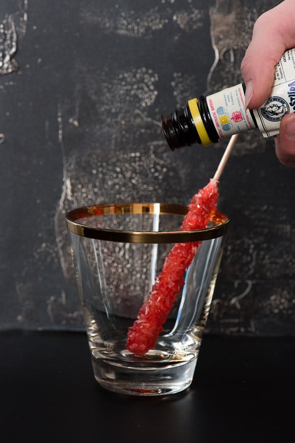 bitters in cocktail glass with swizzle stick