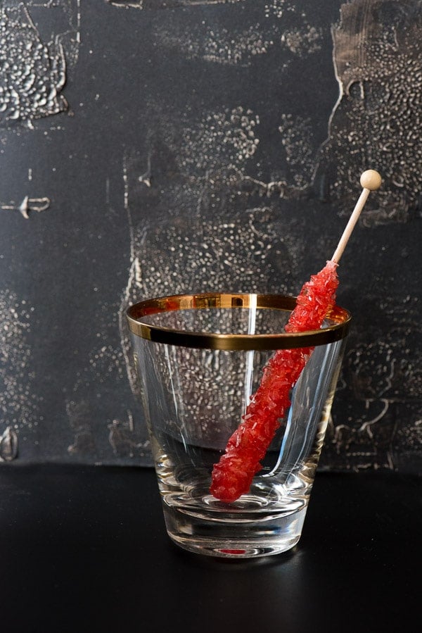 red swizzle stick in cocktail glass
