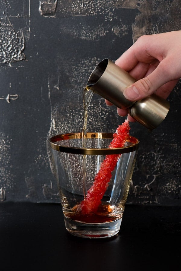 adding alcohol to an old fashioned cocktail